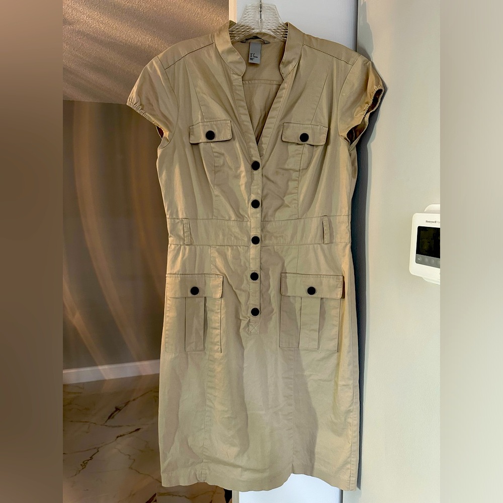 Classic, safari, tan dress. V neck Gorgeous. Sleeveless. Shows off your legs.